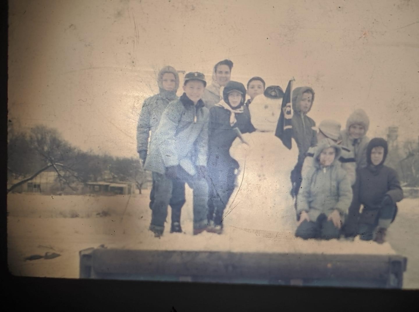 Cub Scouts in Chase.  Mid 50's.  This is their snowman float.  Tom is on the left in a parka.  His mom, Marie, was Den Mother and is in the back.